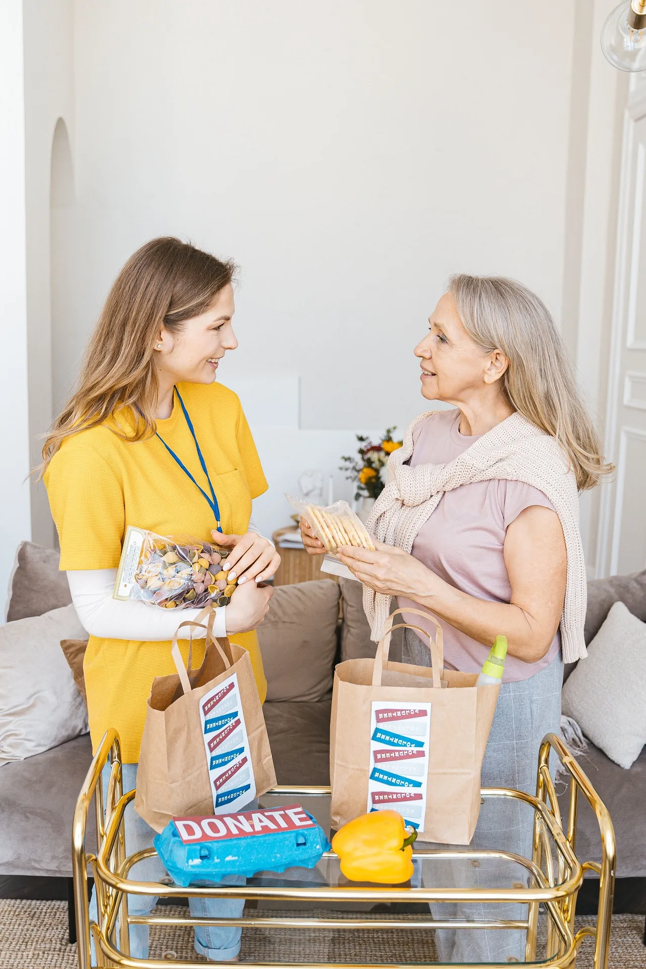 Care worker supporting elderly woman
